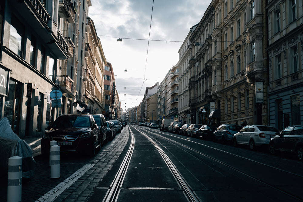 parked cars line an empty city street