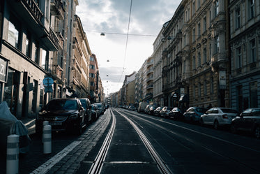 parked cars line an empty city street