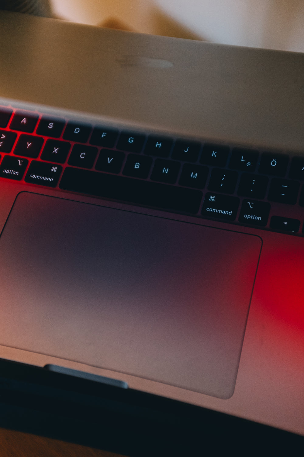 partially closed laptop in red light