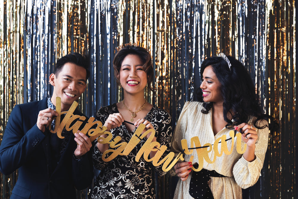 partygoers holding happy new year sign