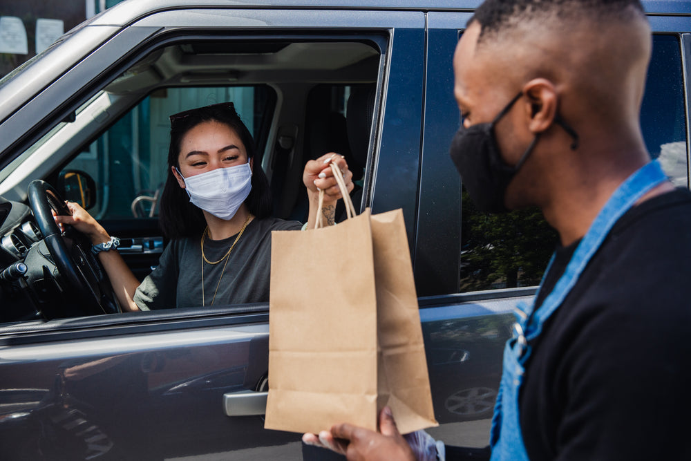 passing curbside pickup order through window