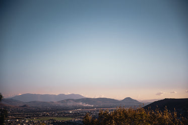 pastel skies over green village