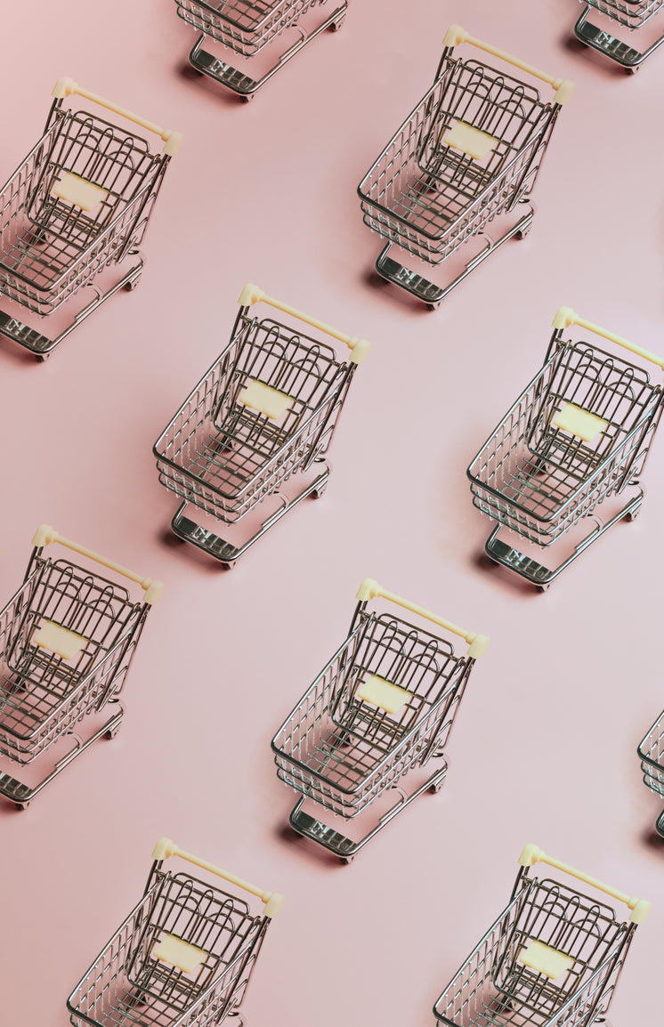 Pattern Of Silver Shopping Carts On A Pink Background