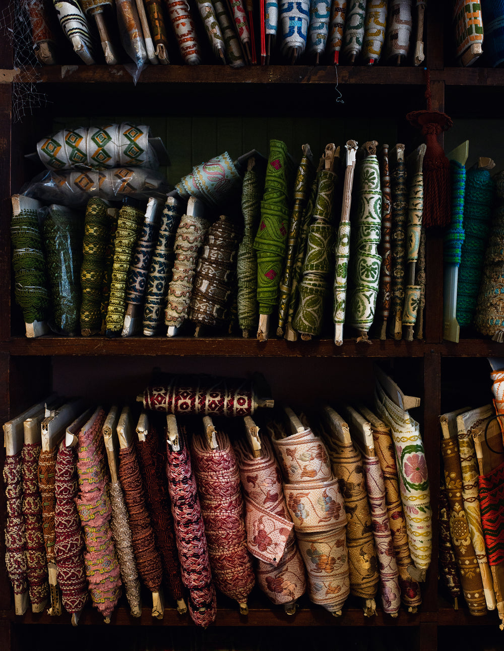 patterned rolls of ribbon wrapped around card line shelves