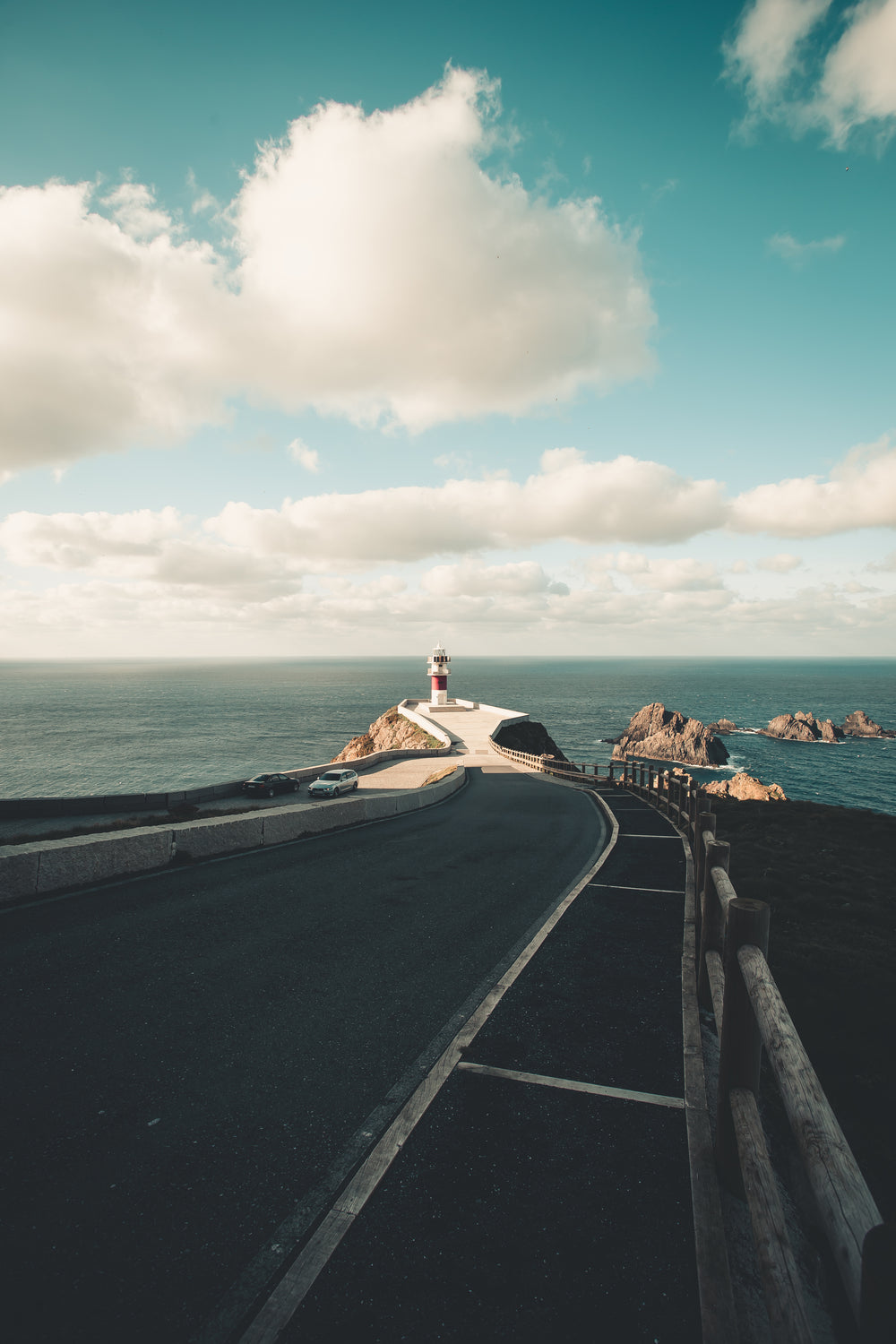 paved road leading to oceanside lighthouse