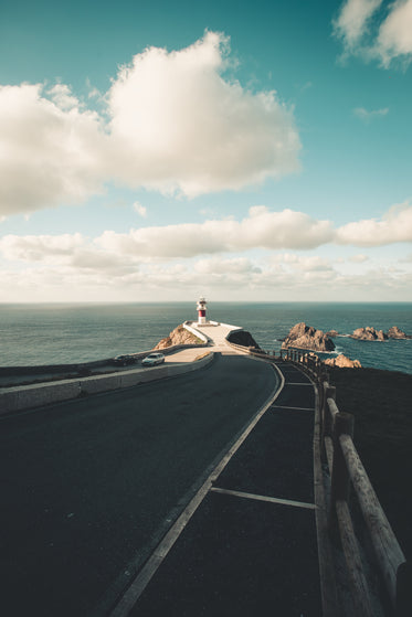 paved road leading to oceanside lighthouse