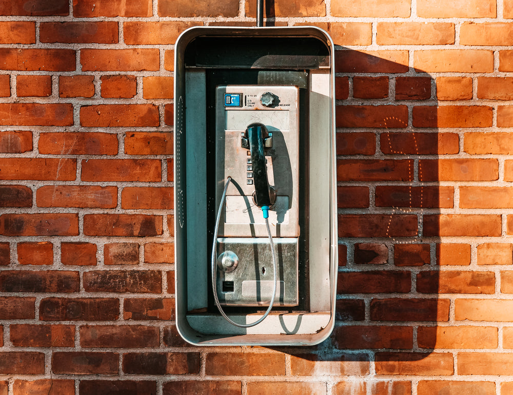 payphone on brick wall