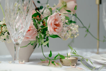 peach roses on table with glass