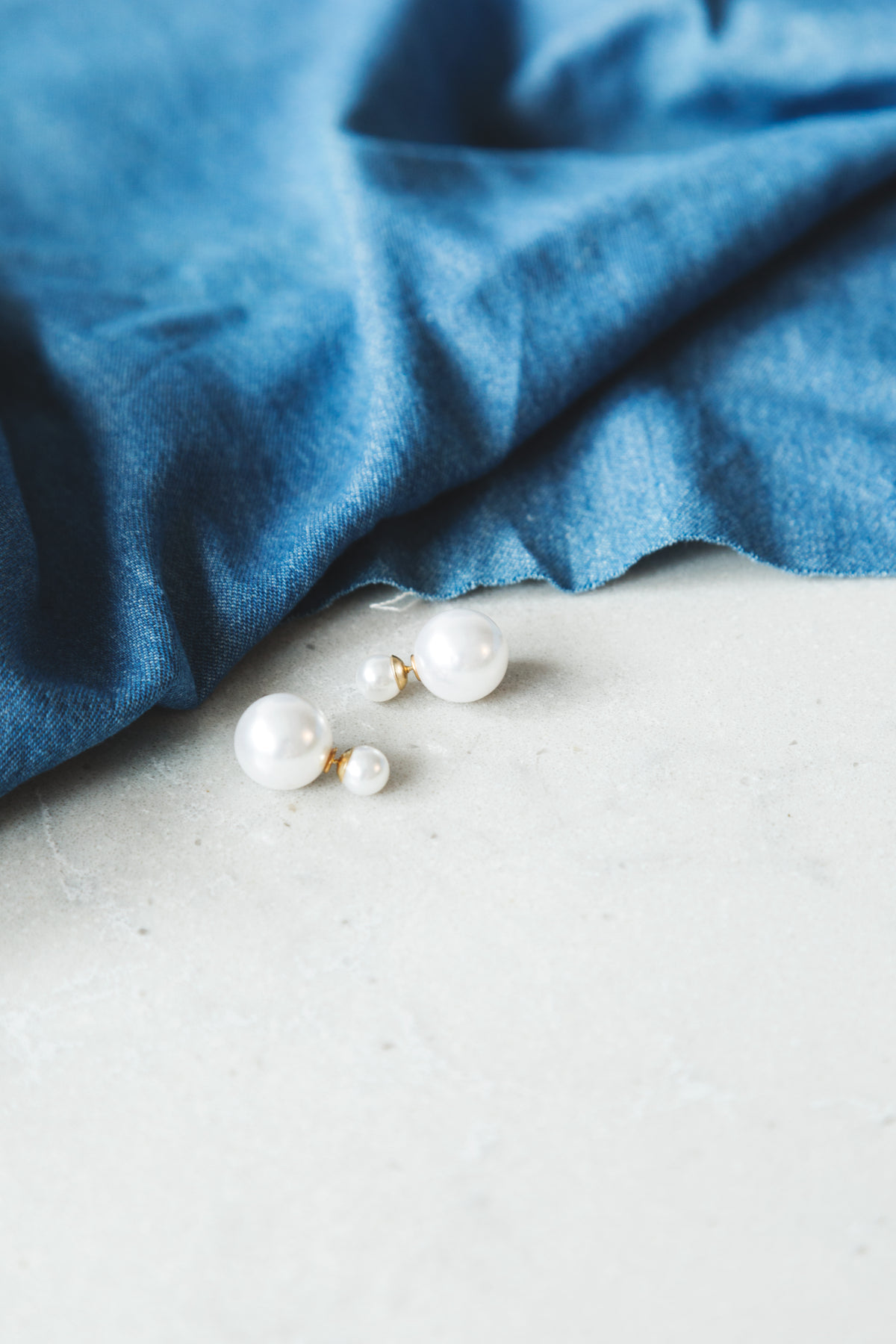 pearl earrings on end table