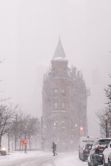 pedestrian crossing toronto street in snow storm