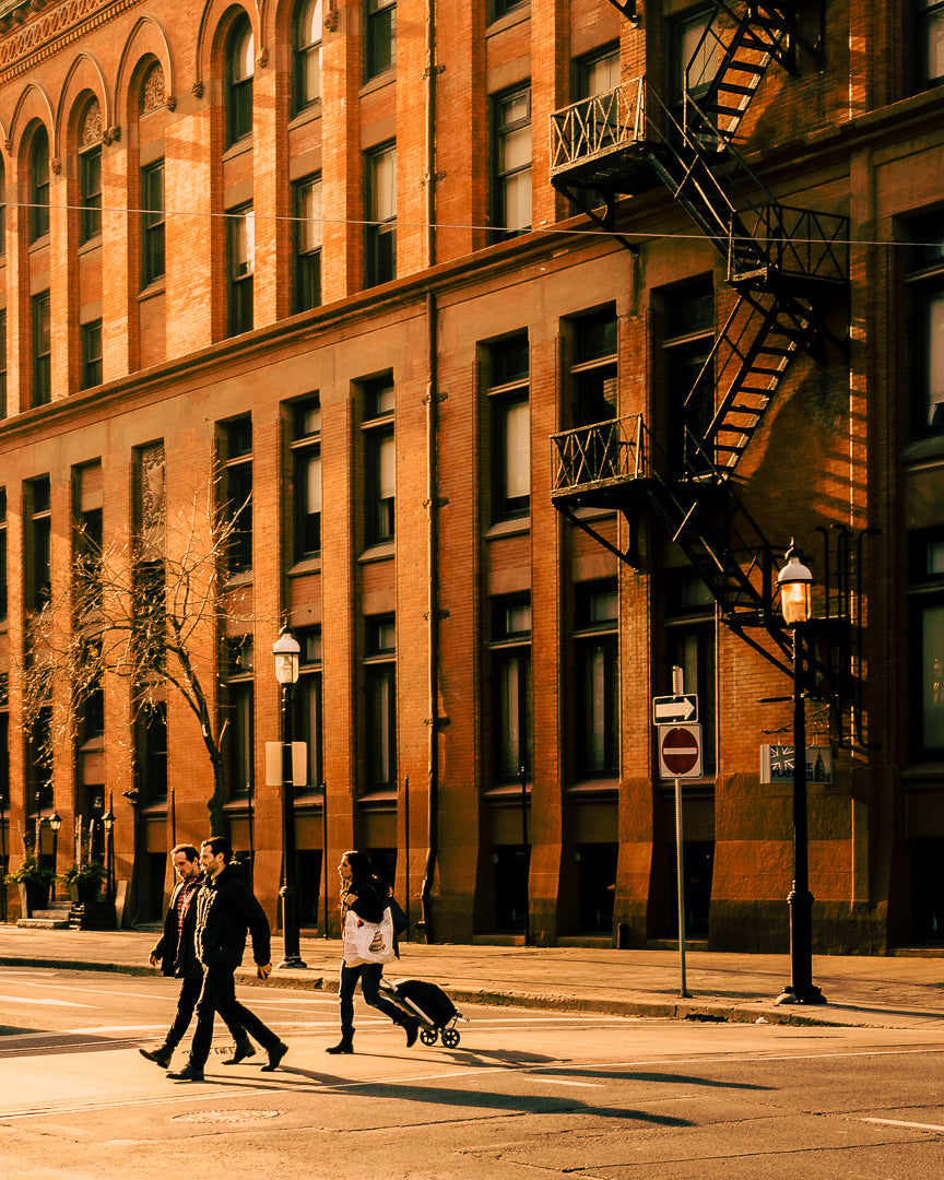 people cross the road in the city morning light