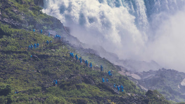 people hiking by waterfall