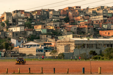 people huddled together on a rust colored field