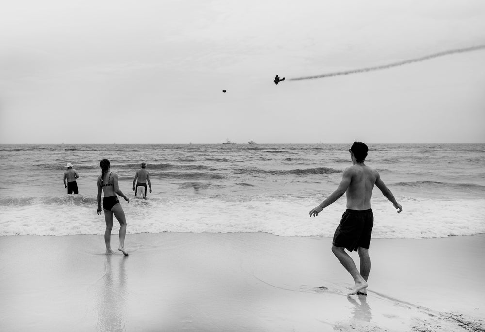 people in the water, planes in the sky