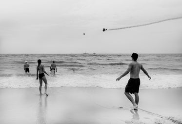 people in the water, planes in the sky