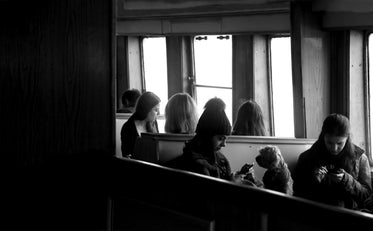 people sitting by a window in conversation