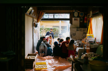 people standing and sitting in a bright room