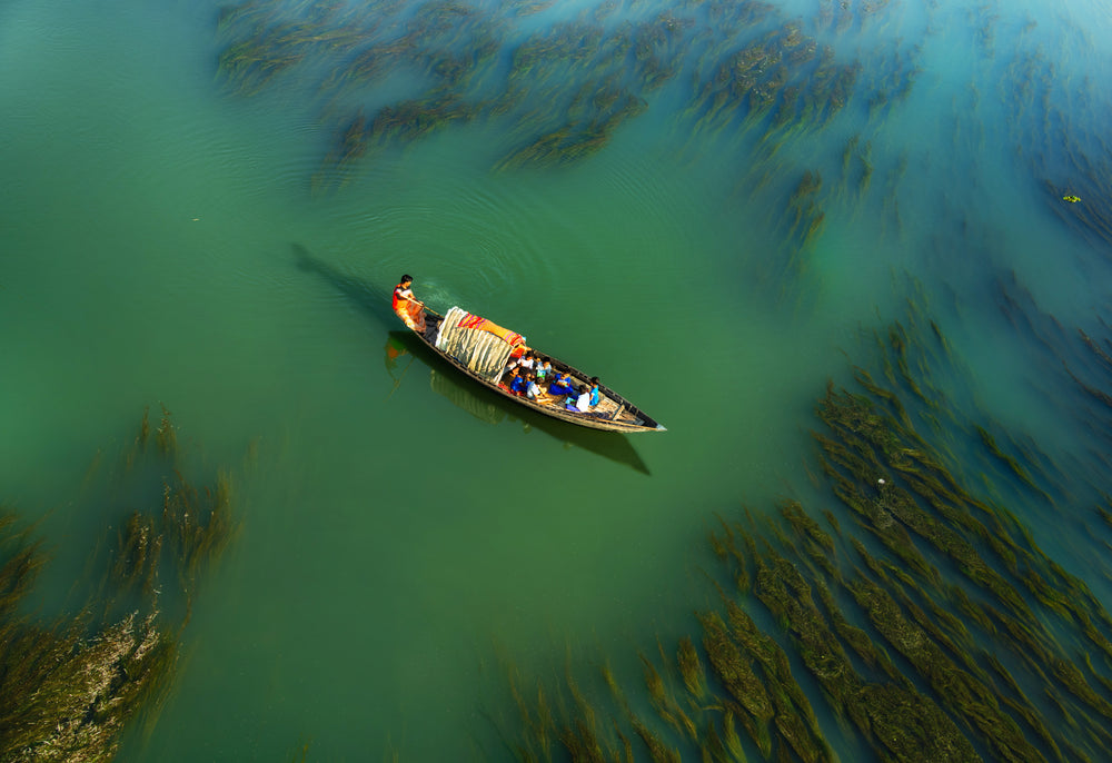 people travelling on a small boat across the water