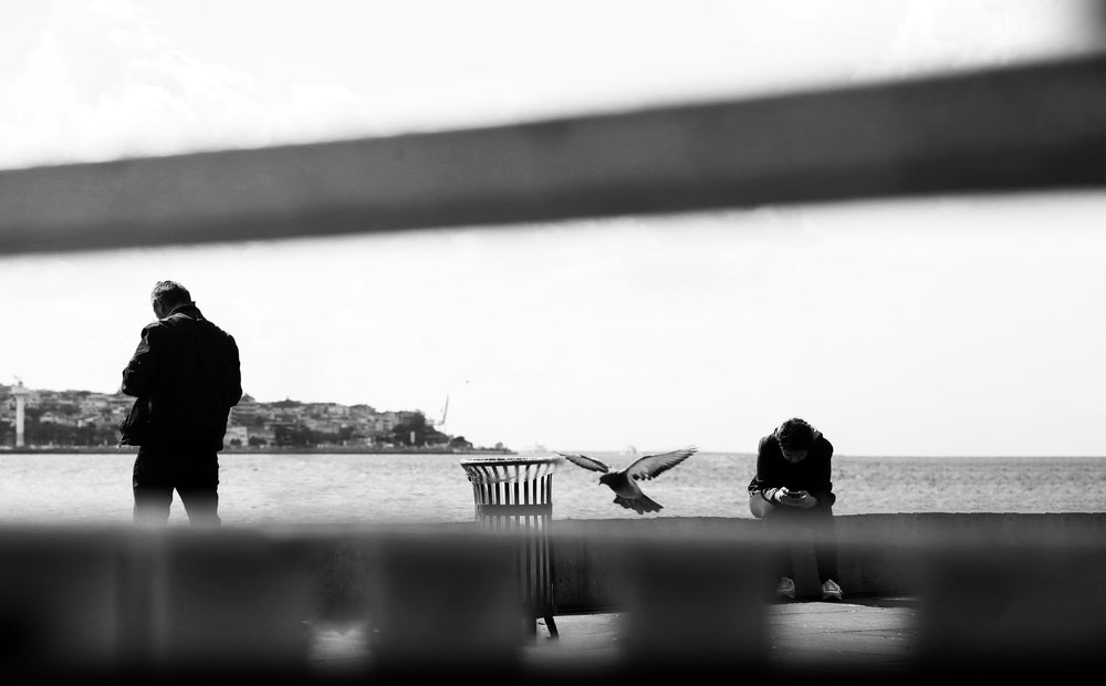 people viewed through blurry bars in black and white