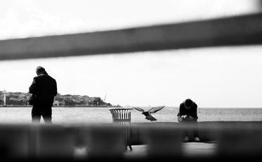 people viewed through blurry bars in black and white