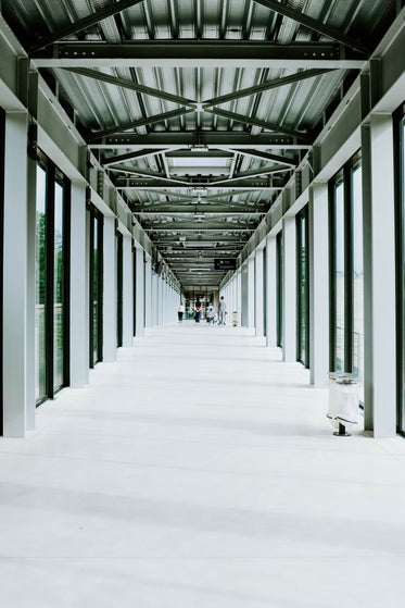 people waiting in a steel frame airport terminal