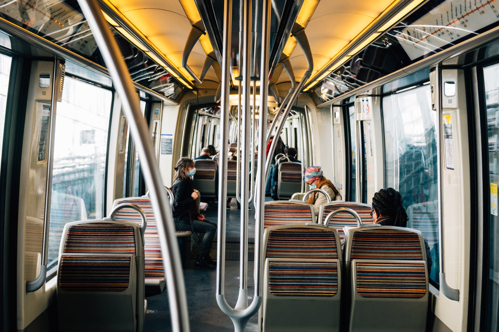 people wearing facemasks commuting on a bus