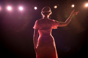 performer on stage in theater lights