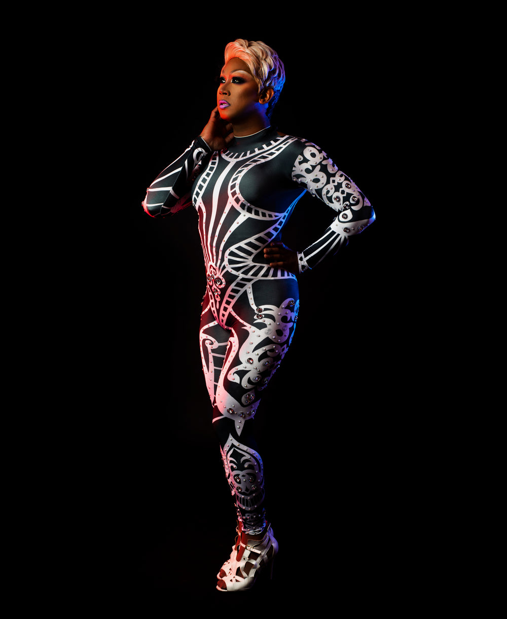 performer posing in red and blue light