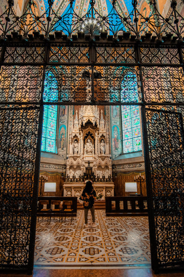 person admires a sculpted altar