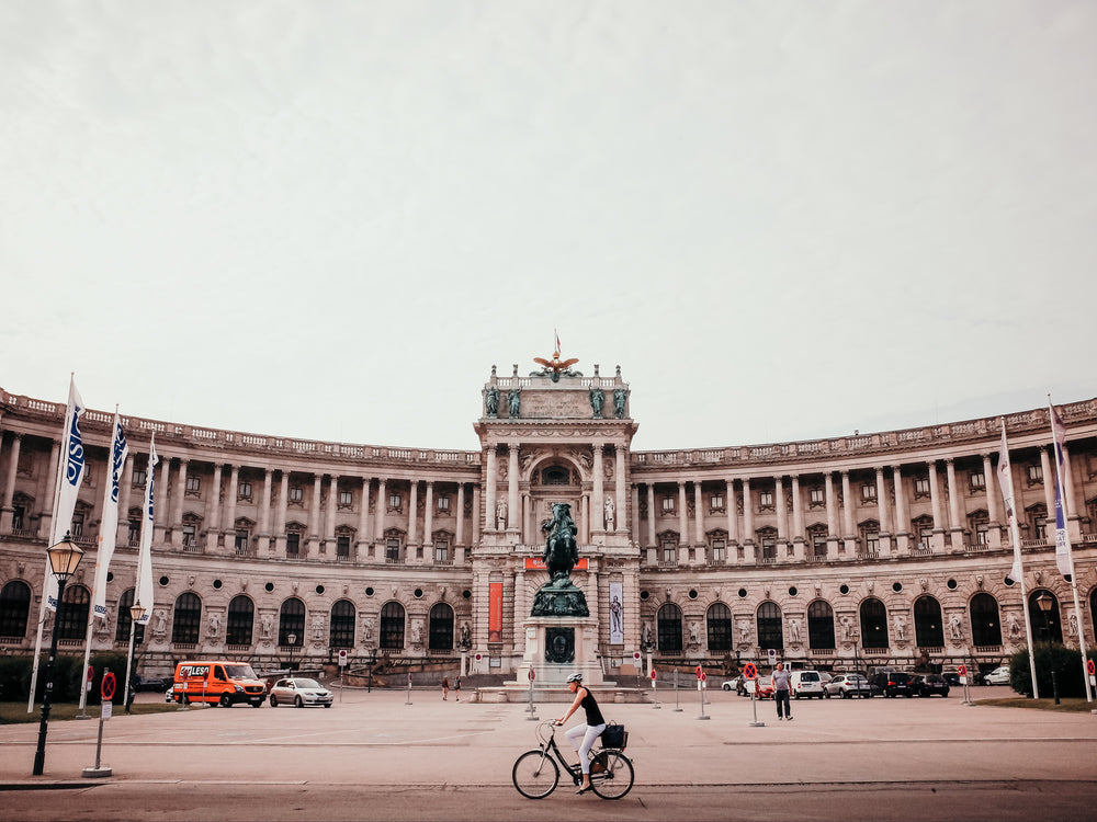 person bikes past wide sculptural courtyard