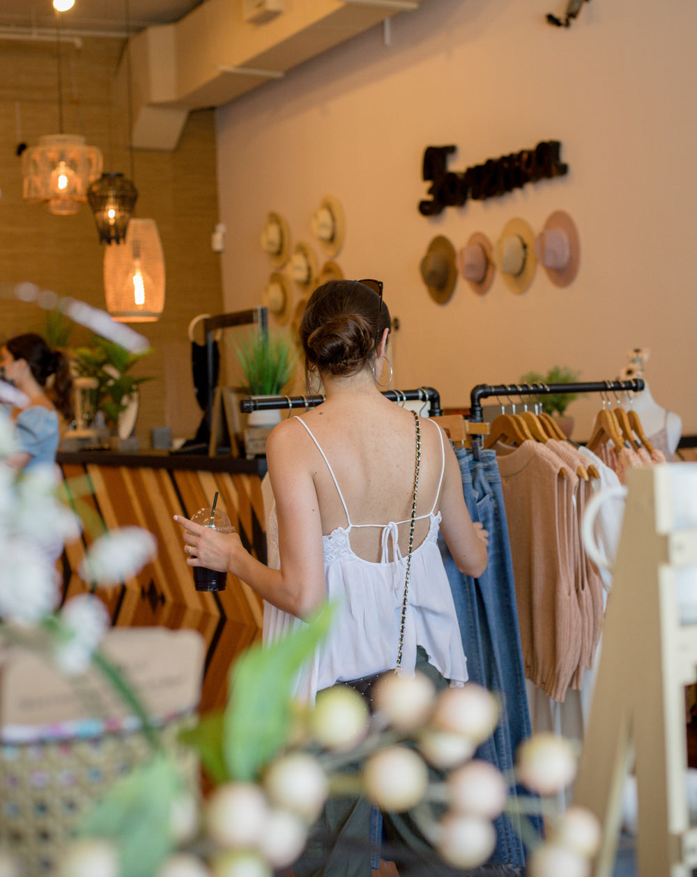 person browses clothing racks in a store