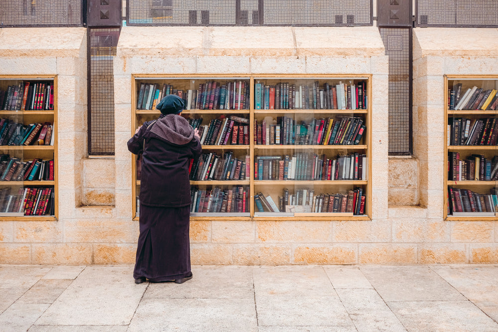 person browsing books in an outdoor library