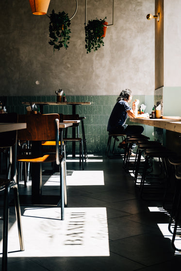 person enjoys lunch alone in a sunlit restaurant