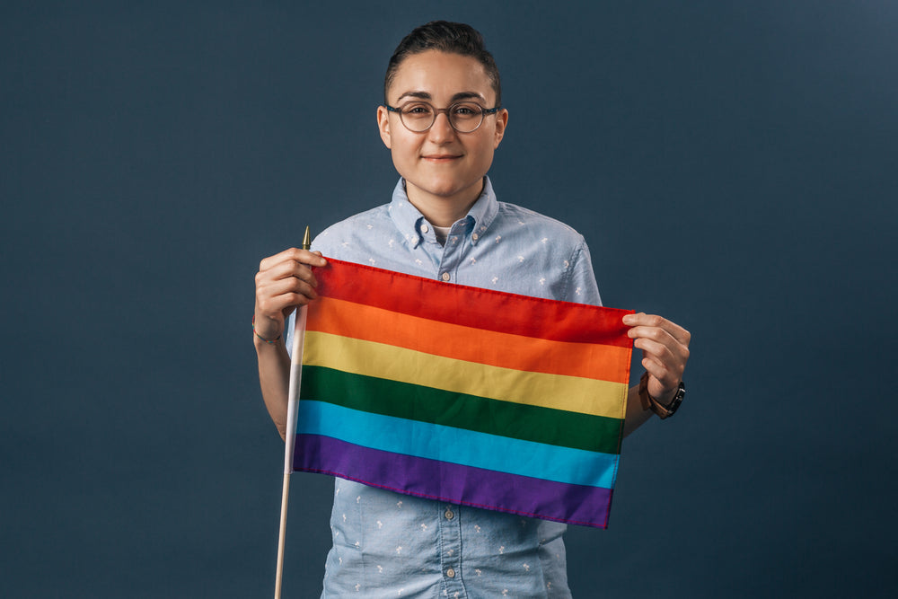 person holding a small pride flag