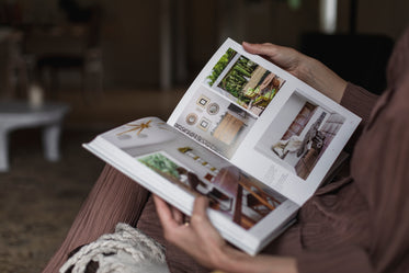person holds open an interior design book