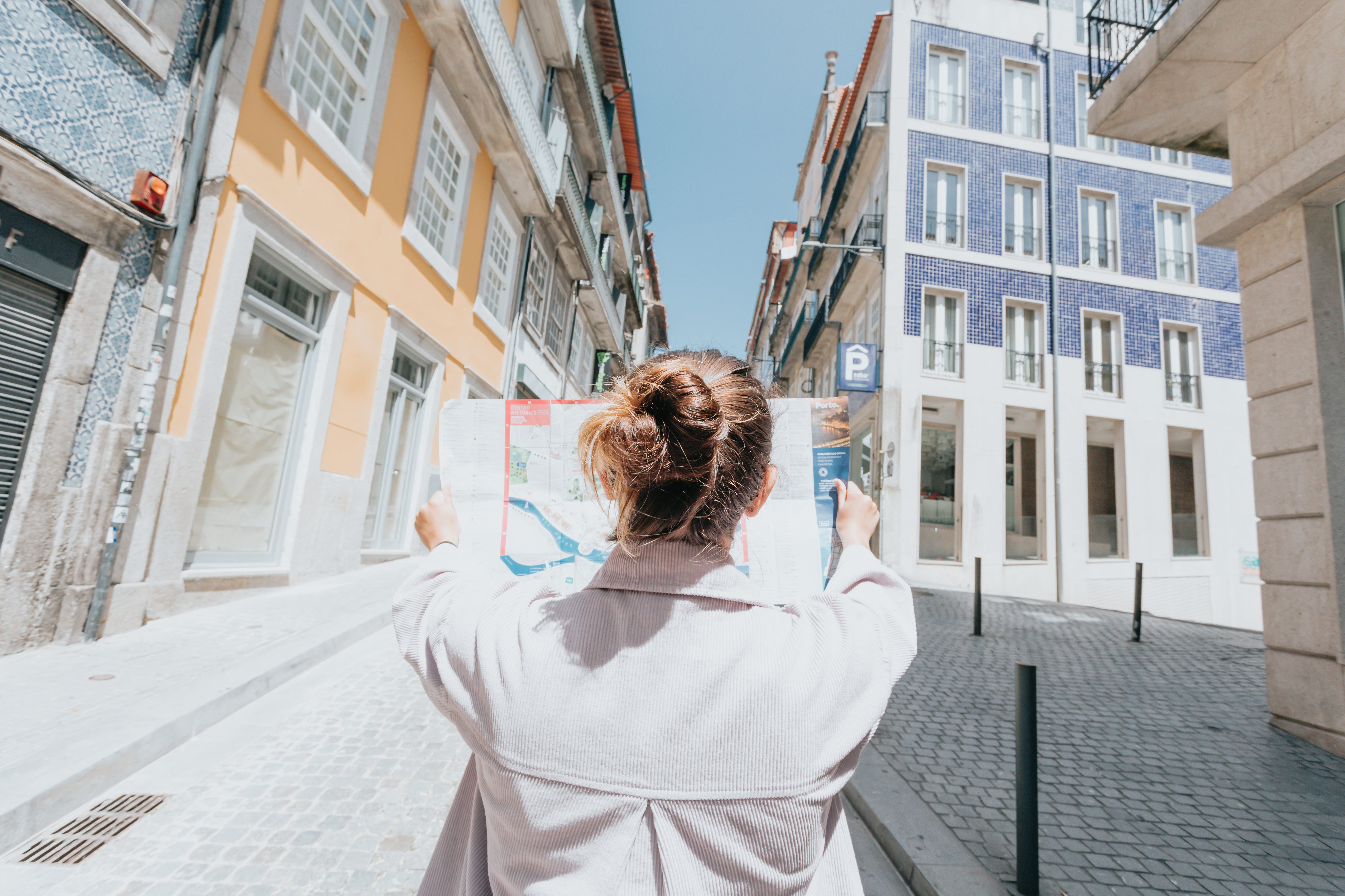 Person Holds Up Map While Standing On A City Street