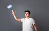 person holds up trans pride flag