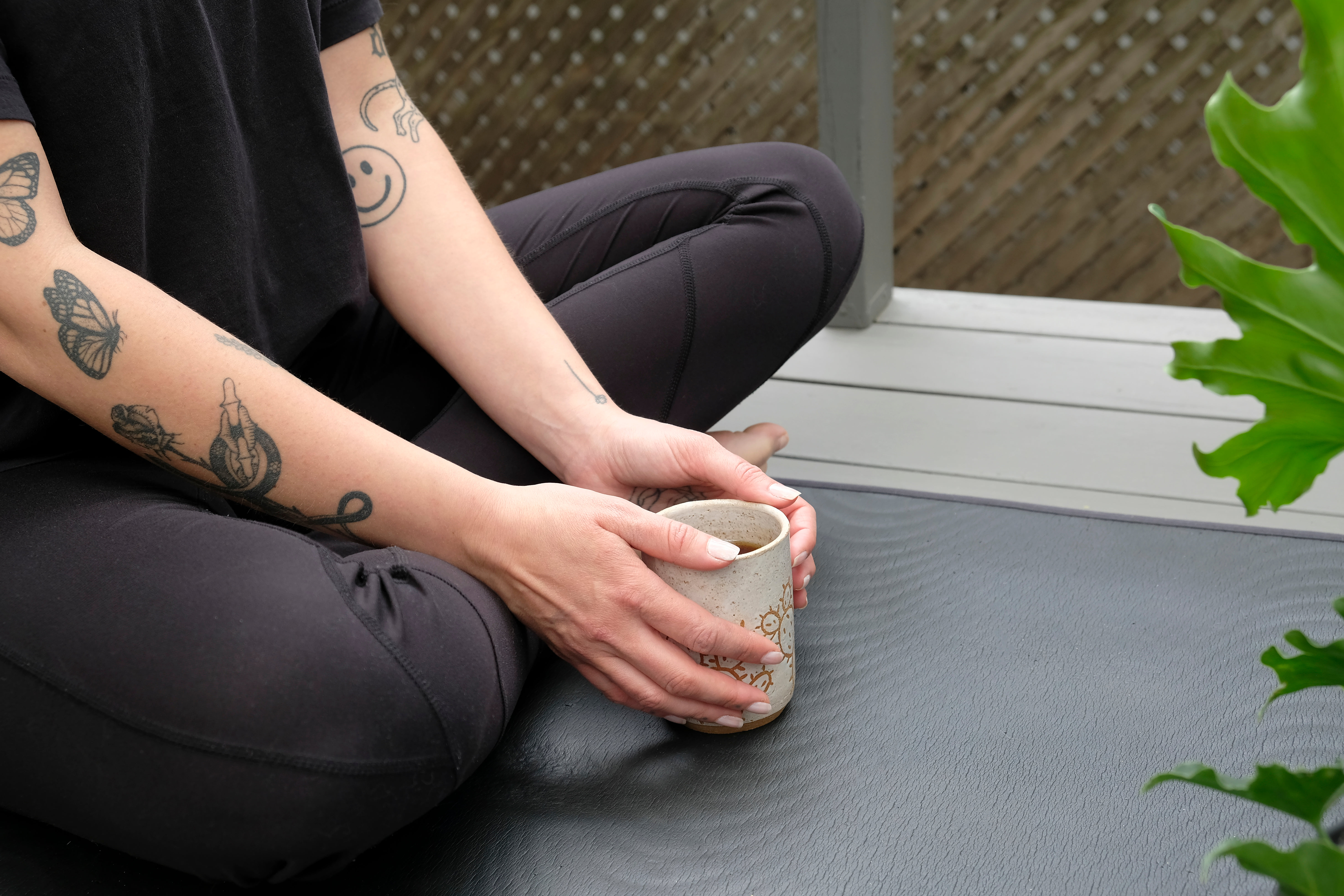 Person In Athletic Wear With A Mug With Both Hands