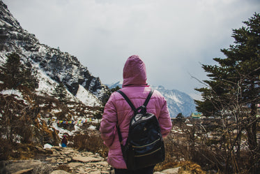 person in pink hiking on a mountain trail