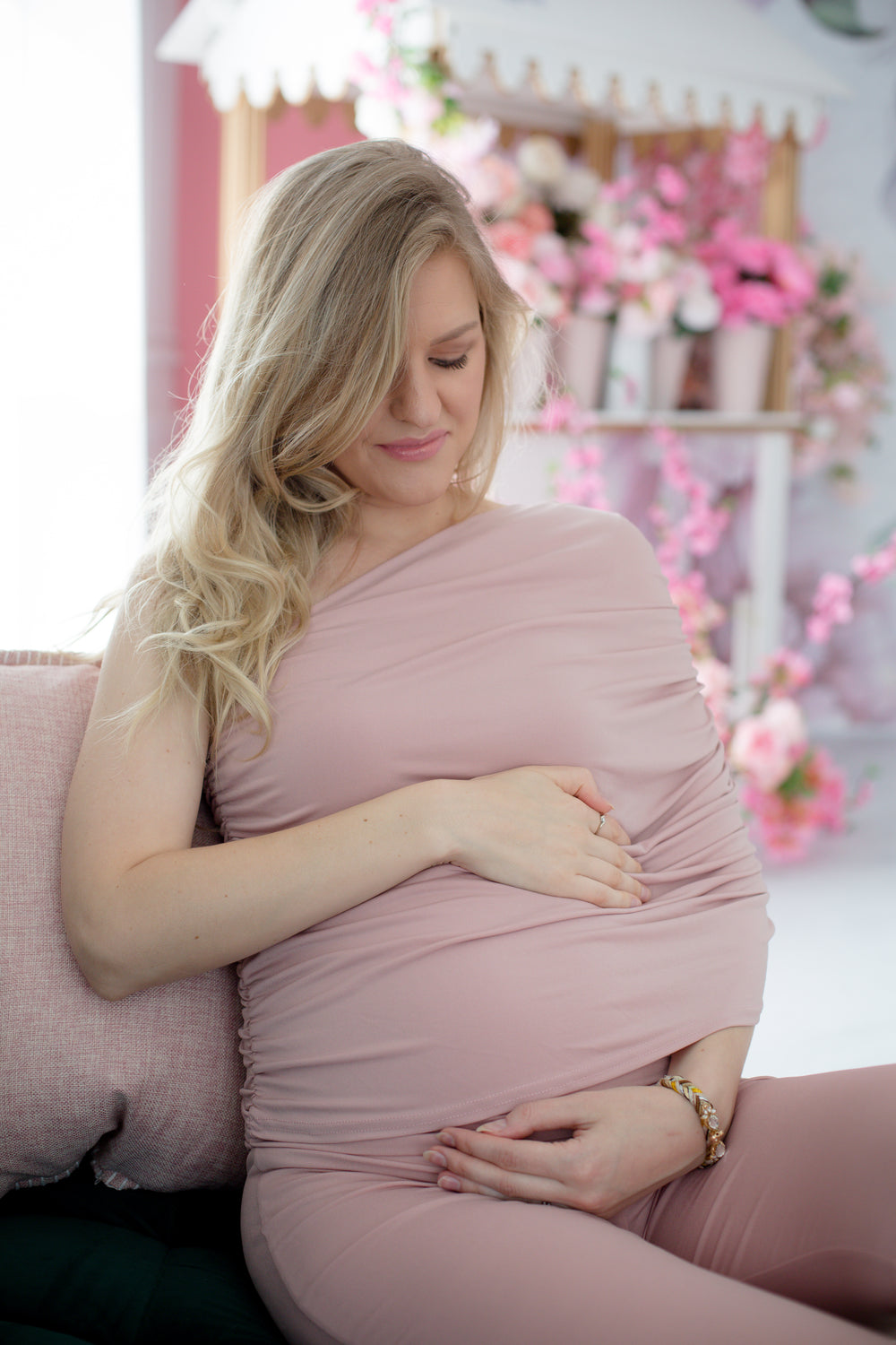 person in pink looks down and holds there belly