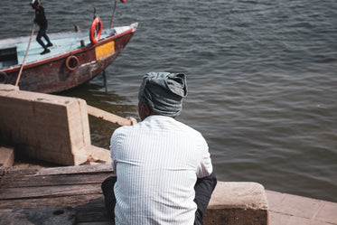 person in scarf looking out at water