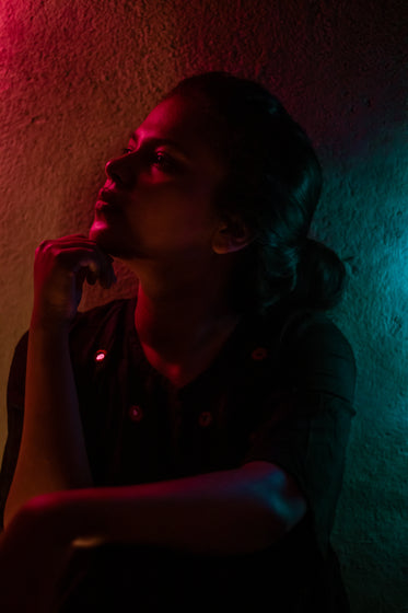 person in thought in pink and blue light