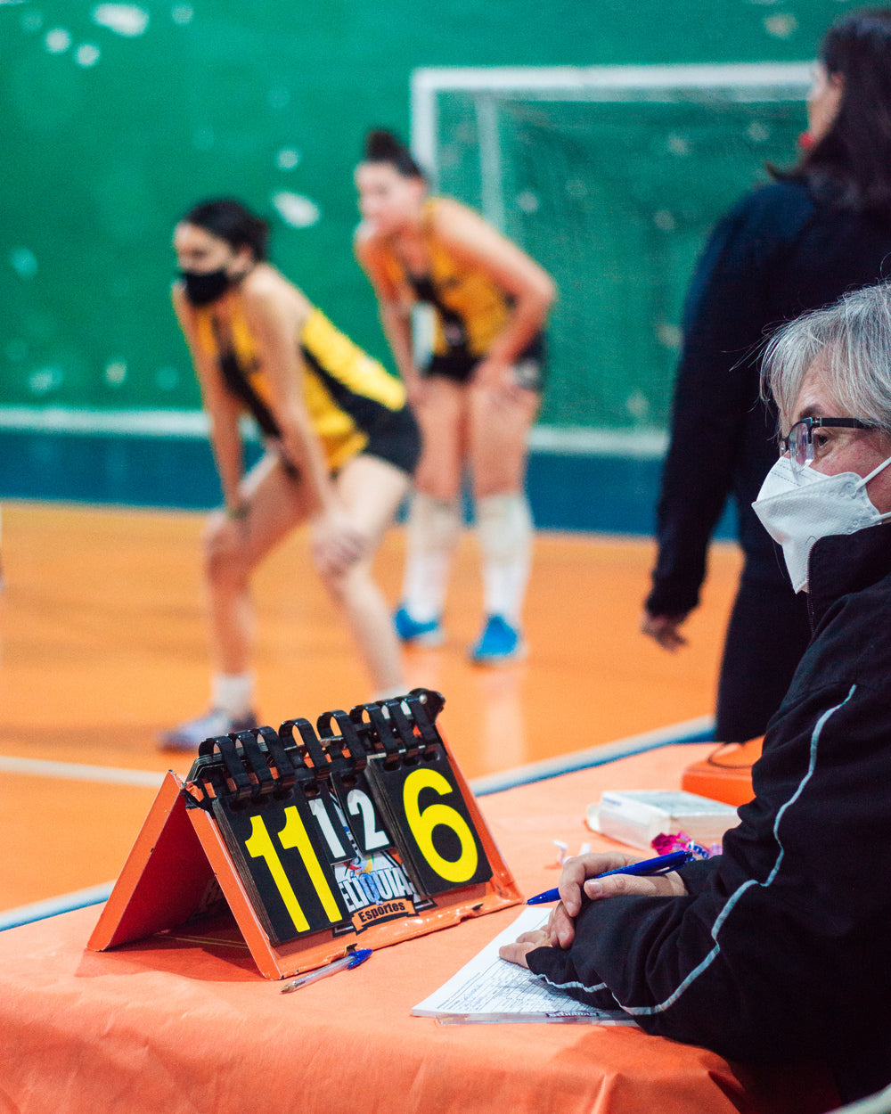 person keeps score at a sports game