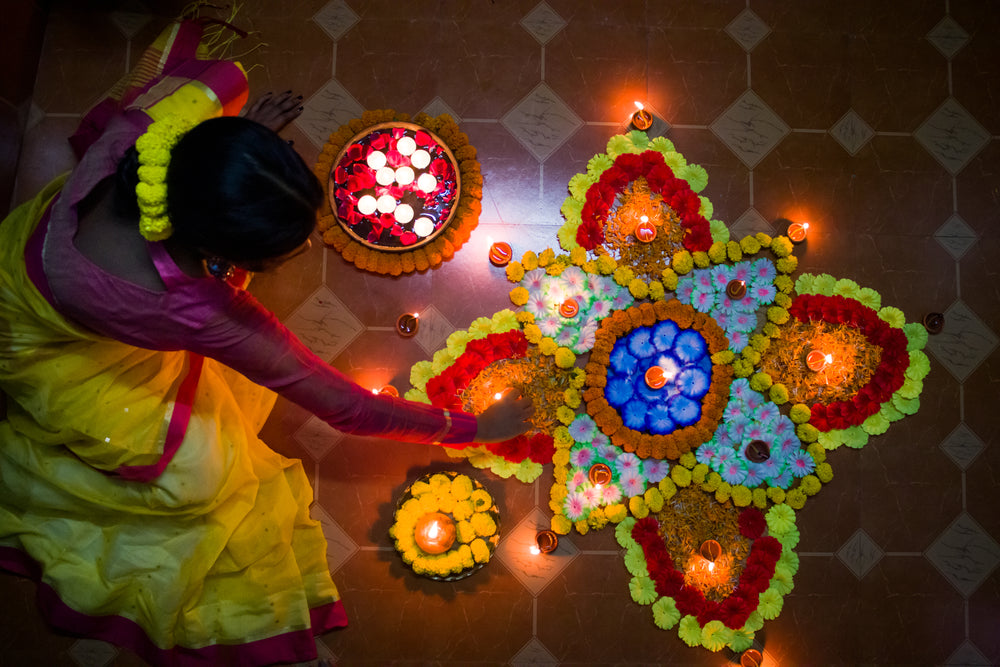 person laying flower petals to form a large flower