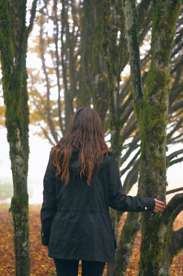 person looks out to moss covered trees