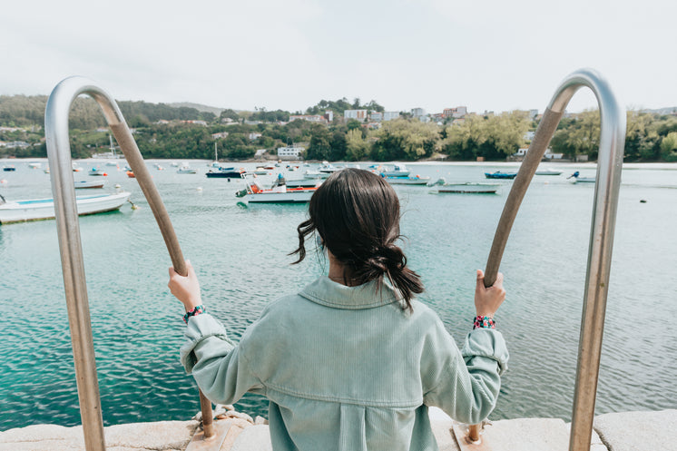 Person Outdoors Looks Out At Boats Below
