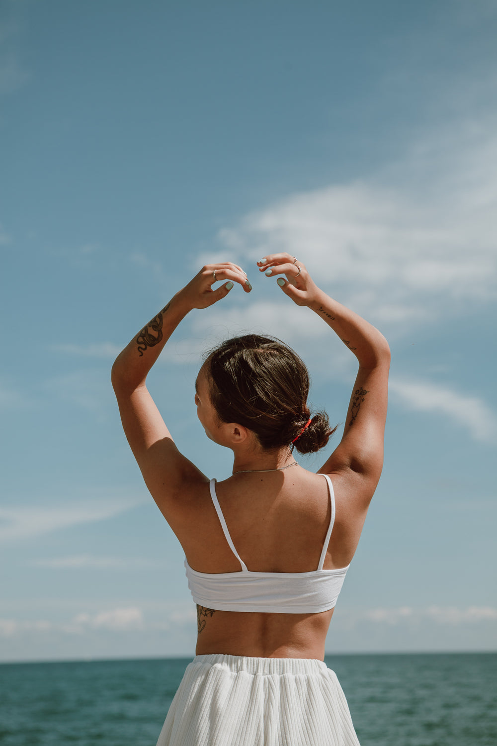 person poses in front of water