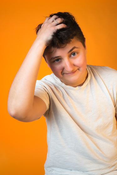 person ruffling their hair portrait