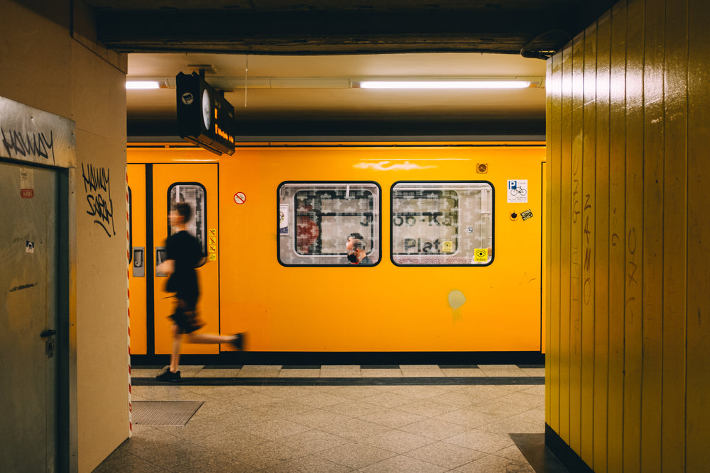 person rushing down subway platform