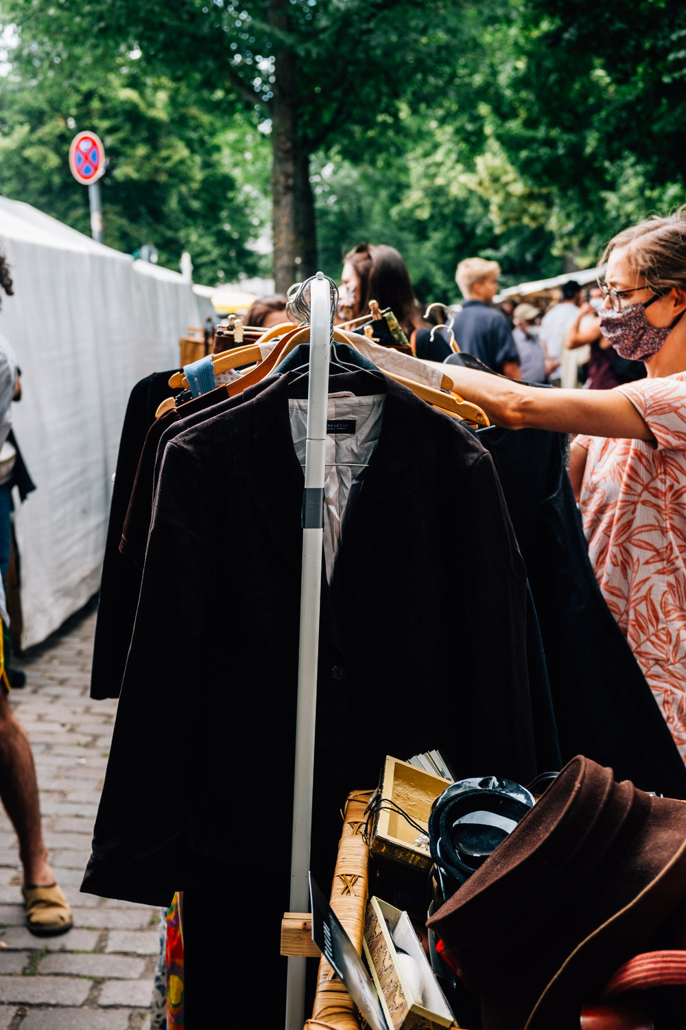 person shops for clothes in an outdoor market